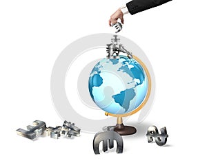 Businessman hand taking money symbols on terrestrial globe