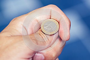 Businessman hand tossing coin to flip on heads or tails