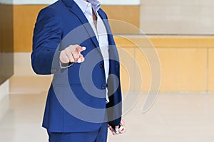 Businessman hand touching empty screen. Handsome man wearing suit.