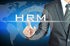 Businessman hand touching HRM (Human Resources Management) sign
