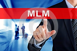 Businessman hand touching MLM (Multi Level Marketing) sign on vi