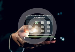 Businessman hand touching screen of calendar event plan and digital schedule appointments on internet