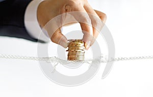 Businessman hand try to sustain balancing golden coins row photo