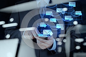 Businessman hand use smart phone computer with email icon