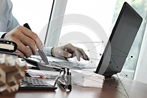Businessman hand using laptop and mobile phone