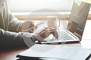 businessman hand using laptop and smart phone