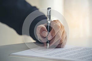 Businessman hand using pen signing on new contract to starting projects in conference room. Close up business manager man hands