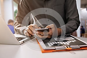 Businessman hand using smart phone, laptop payments online shopping, omni channel, digital laptop docking keyboard computer at