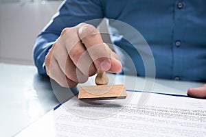 Businessman Hand Using Stamper On Document