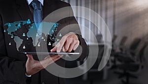 Businessman hand using tablet computer and board room