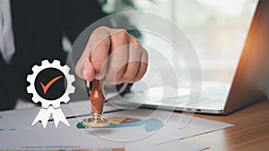 Businessman hand using wooden stamping to document approve and reject document or project, Signing a business contract approval of