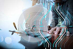 businessman hand working with new modern computer and smart phone and business strategy on wooden desk with calculator and eye