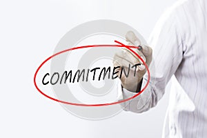 Businessman Hand Writing commitment with a marker over transparent board, Business concept.