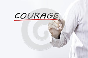 Businessman hand writing COURAGE with red marker on transparent