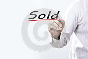 Businessman hand writing Sold, Business concept.