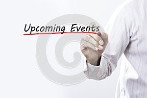 Businessman hand writing Upcoming Events, Business concept. photo