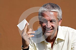 Businessman handing blank business card