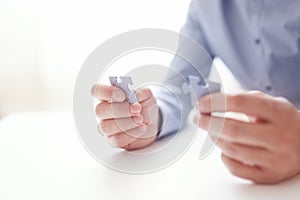 Businessman hands connecting jigsaw puzzle. Business solutions, success and strategy, learning concept. Close up photo