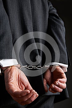 Businessman With Hands Cuffed Behind Back