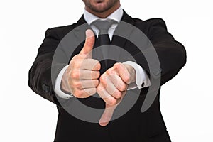 Businessman' hands giving a thumbs up and down close-up
