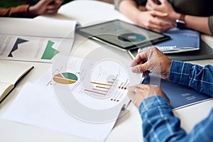 businessman hands holding financial document discussing data with colleagues in meeting brainstorming ideas using graph