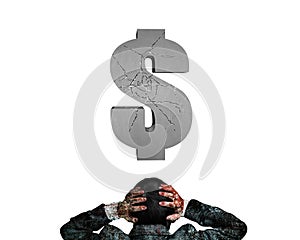 Businessman hands holding head facing cracking 3D concrete dollar sign