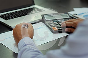 Businessman hands holding pens and business documents at desk and calculator. Business, finance, tax and investment concept