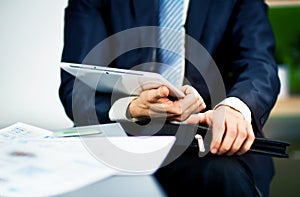 Businessman hands are holding the touch screen