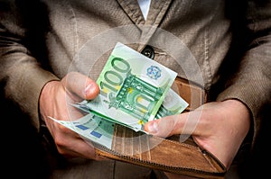 Businessman hands holding wallet with stack of money