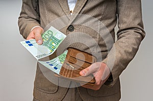 Businessman hands holding wallet with stack of money