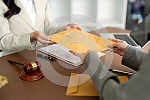 Businessman hands money envelope to lawyer in bribe over illegal business contract documents Investing, accepting bribes