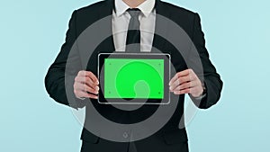 Businessman, hands and tablet with green screen in advertising or marketing against a studio background. Closeup of man