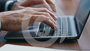 Businessman hands texting laptop making notes in notebook close up. Man typing