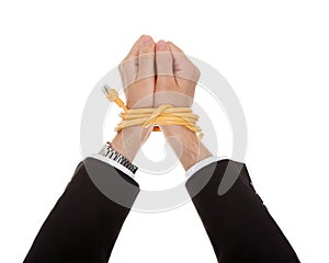 Businessman with hands tied in network cable