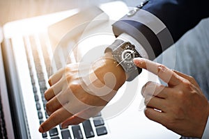 Businessman hands touching smart watch. Using a compass app