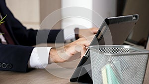 Businessman hands typing on the computer then multitasking on the tablet PC