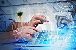 Businessman hands typing on keyboard, a digital globe hologram with network icons