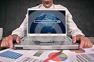 businessman hands typing on laptop keyboard with graphs and charts