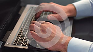 Businessman hands typing on laptop, pressing buttons on keyboard