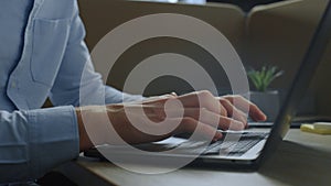 Businessman hands using touchpad on laptop. Employee typing on computer keyboard