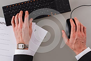 Businessman hands working at desk in office.