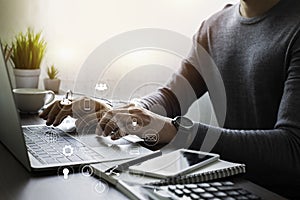 Businessman hands working with laptop computer on office desk.