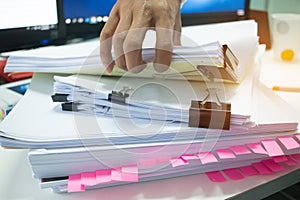 Businessman hands working on Stacks of documents files for finance in office. Business report papers or Piles of unfinished