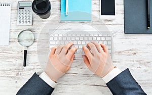 Businessman hands working at vintage wooden desk