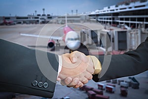 Businessman handshake with air plane transportation