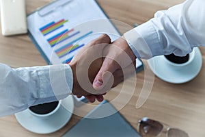 businessman handshake on coffee table.Businesspeople shaking hands after a successful meeting