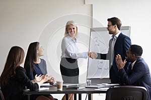 Businessman handshake female employee greeting with promotion