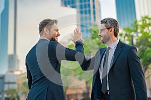 Businessman handshake with partner. Two businessmen shaking hands outdoor. Business mens growth strategy. Business men