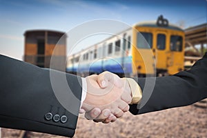 Businessman handshake with train transportation logistic