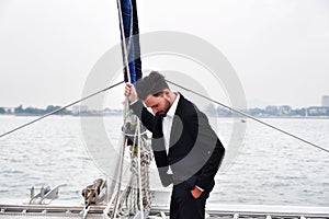 Businessman handsome man wearing suit on sailing boat